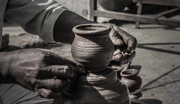 Cropped hands of porter shaping earthenware