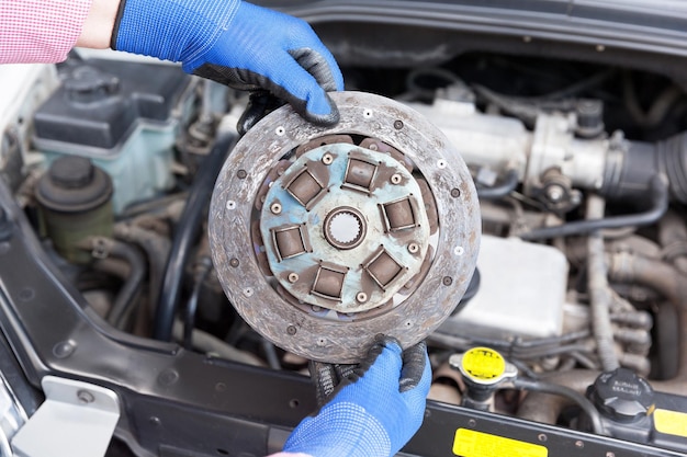 cropped hands repairing car engine