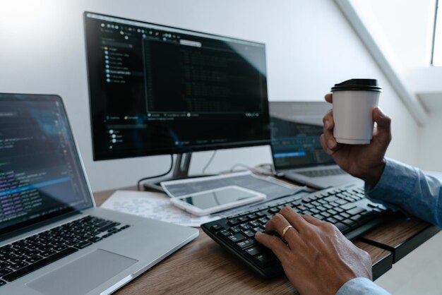 Photo cropped hands of software programmer working on table