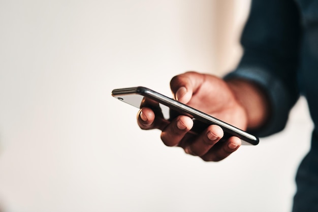 cropped hands using mobile phone