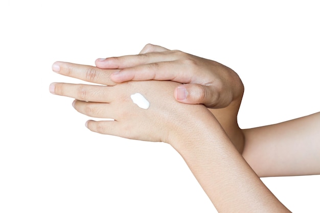 Photo cropped hands of woman applying cream against white background