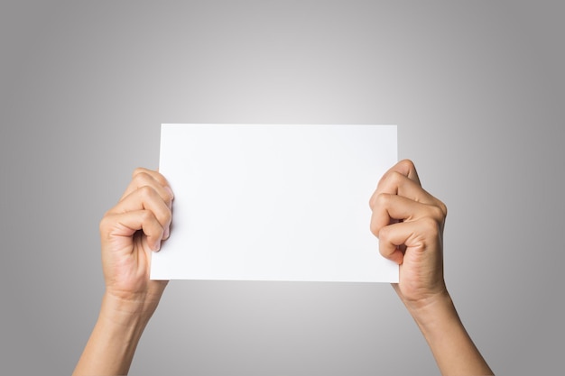 Photo cropped hands of woman holding blank paper against gray background