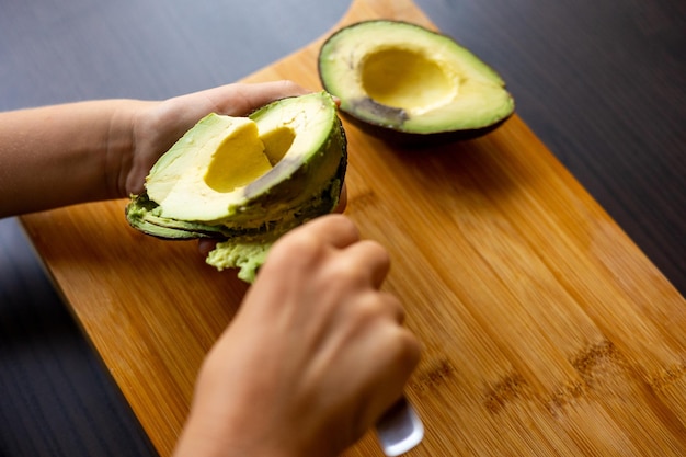 Cropped hands of woman holding fruit on table