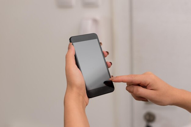 Cropped hands of woman using mobile phone