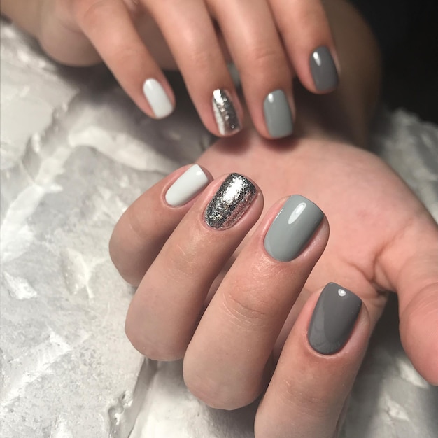 Cropped hands of woman with nail polish on table