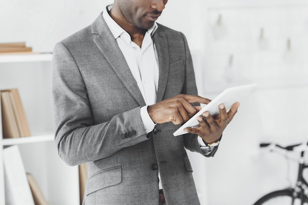 cropped image of african american man using tablet