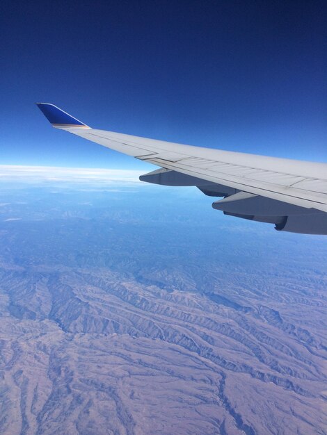 Cropped image of airplane flying over landscape