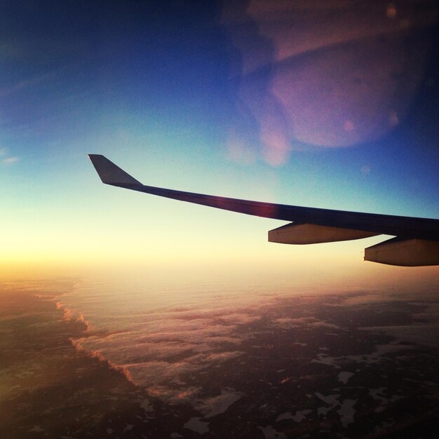 Photo cropped image of airplane flying in sky