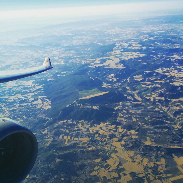 Cropped image of airplane over landscape