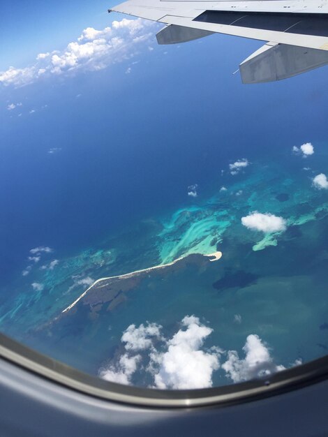 Cropped image of airplane wing over landscape