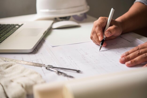 Photo cropped image of architect making blueprint in office