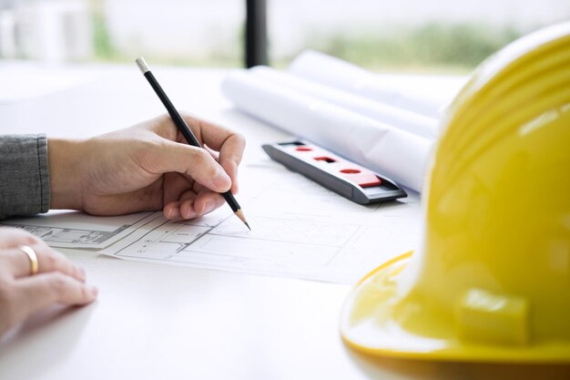 Cropped image of architect making blueprint in office