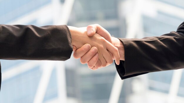 Cropped image of business people shaking hands