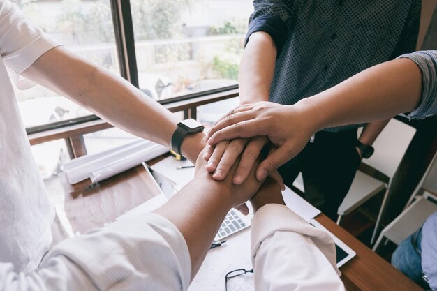 Cropped image of business people showing unity