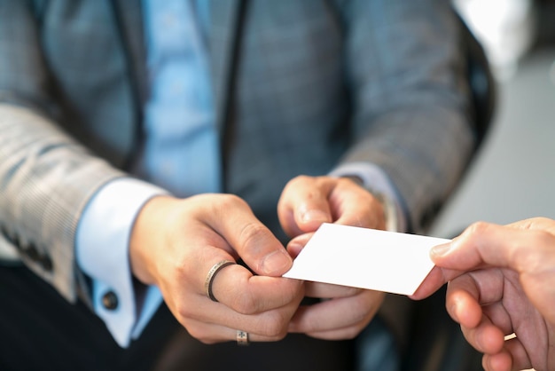 Cropped image of business person giving business card