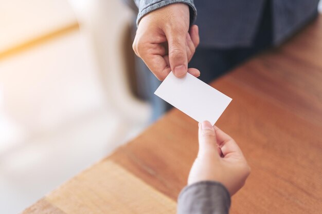 Cropped image of business person giving business card