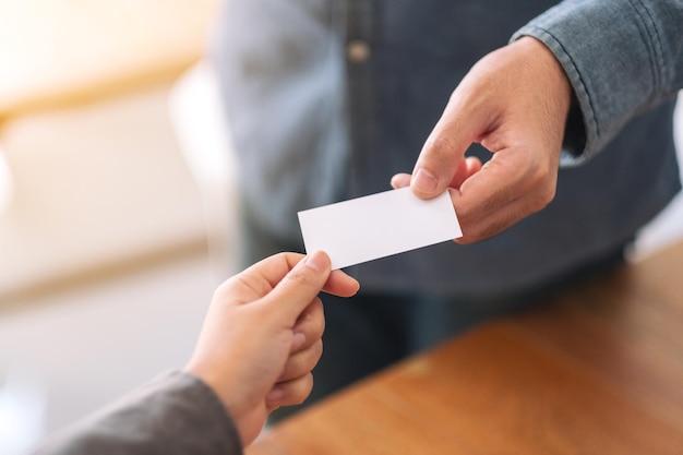 Cropped image of business person giving business card