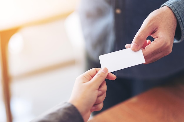 Photo cropped image of business person giving business card