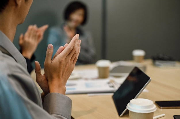 Cropped image of business professionals applauding during a seminar in the conference room