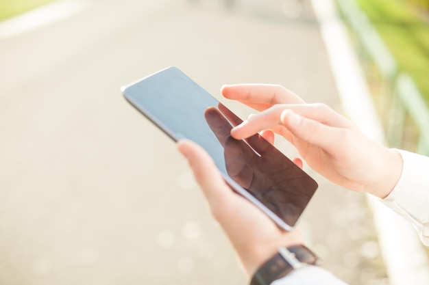 cropped image of businessman using digital table on road