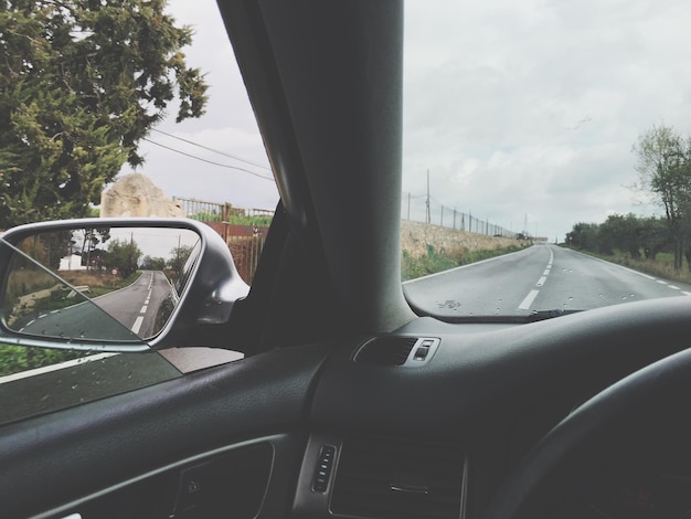 Cropped image of car on road