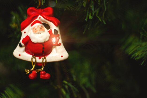 Cropped image of christmas tree with red toy.