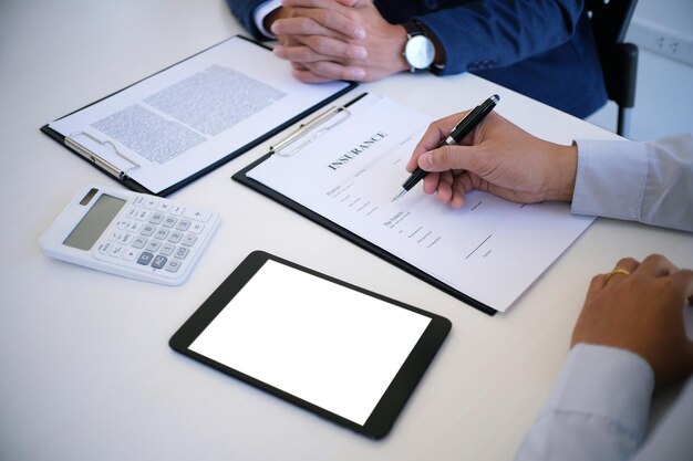 Cropped image of colleagues working at desk in office