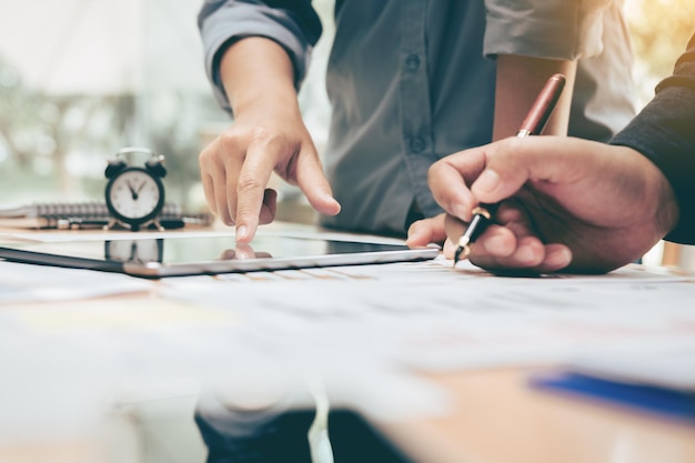 Cropped image of colleagues working at desk in office