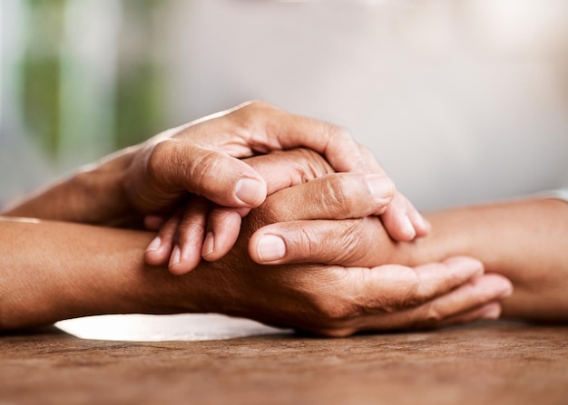 Cropped image of couple holding hands