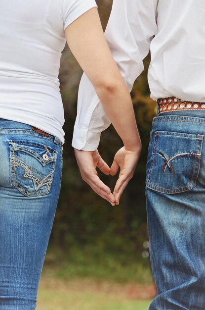 Foto immagine ritagliata di una coppia che fa la forma di un cuore con le mani