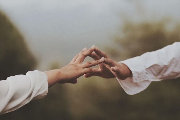 cropped image of couple touching each others hand