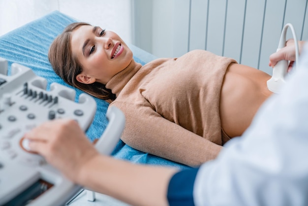 Cropped image of female doctor ultrasound examine female patient at hospital