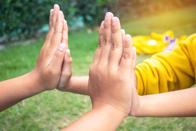 Photo cropped image of friends touching hands outdoors