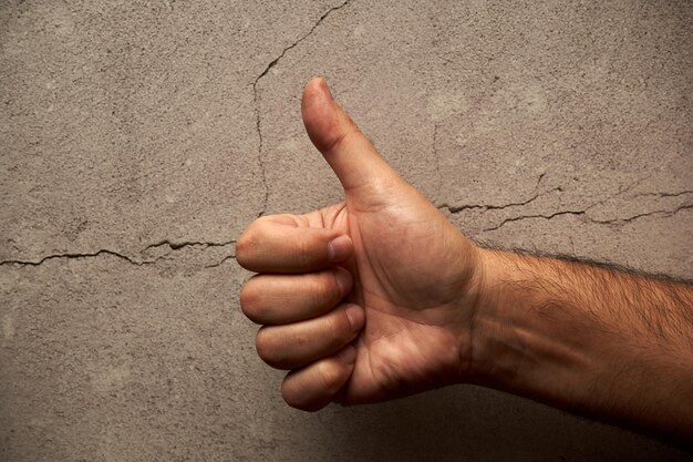 Cropped image of hand against wall