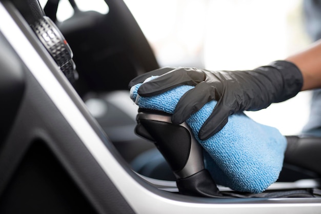 Photo cropped image of hand cleaning gearshift