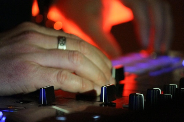 Photo cropped image of hand holding guitar