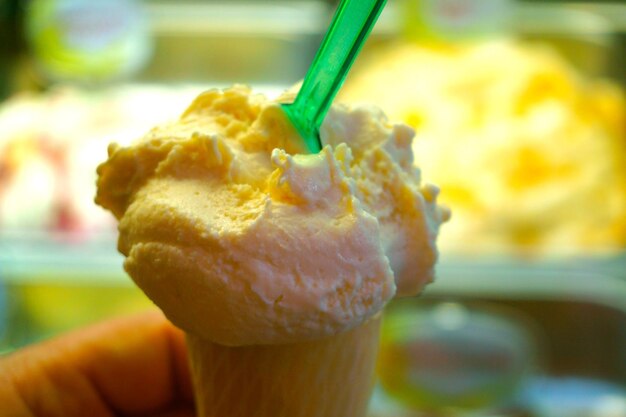 Cropped image of hand holding ice cream