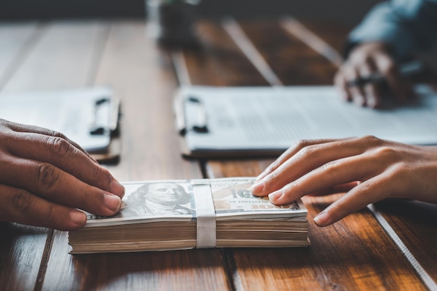 cropped image of hand holding paper on table