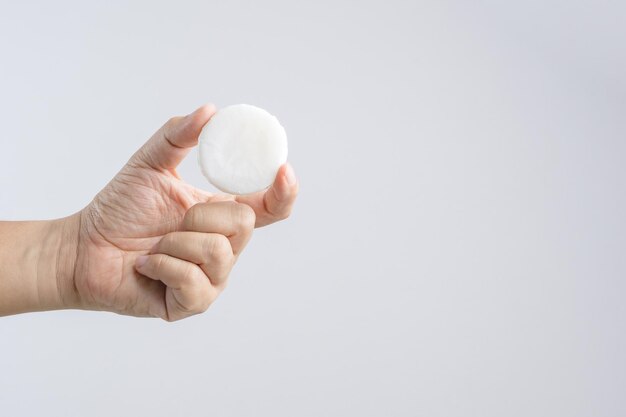 cropped image of hand holding soap against white background