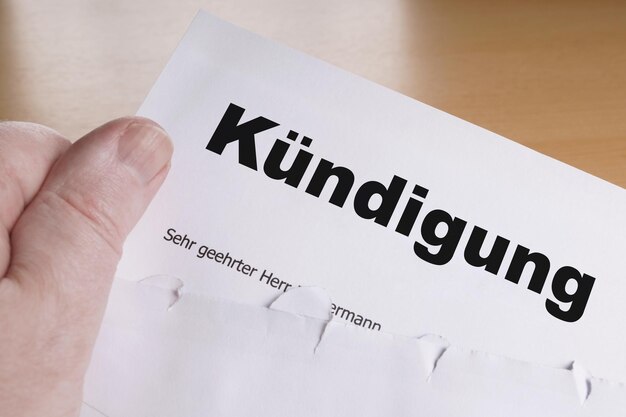 Cropped image of hand holding text on paper