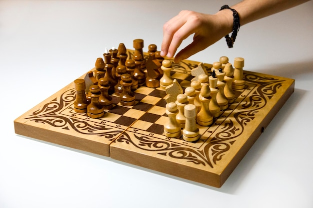 cropped image of hand playing chess on white background