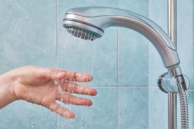 Cropped image of hand playing with ball in bathroom