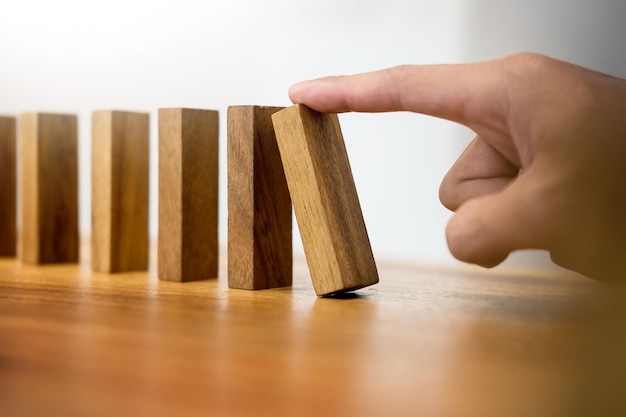 Cropped image of hand pushing toy blocks on table