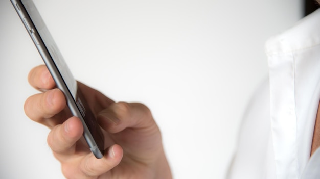 Photo cropped image of hand using mobile phone against white background