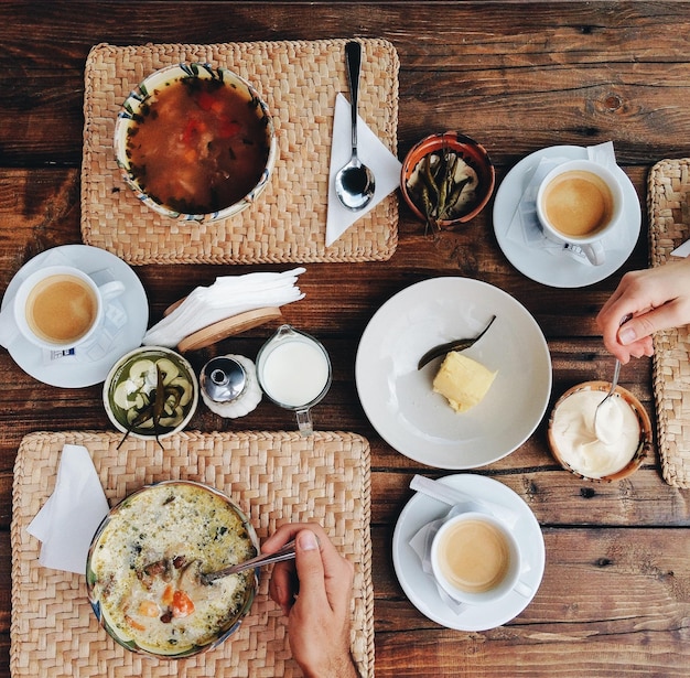 Cropped image of hands having food at table