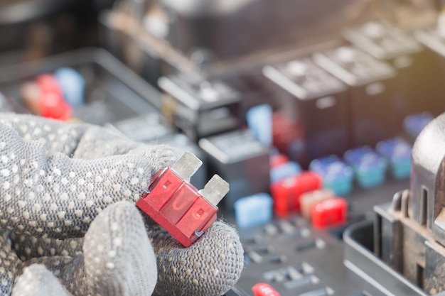 Cropped image of hands holding tool on vehicle