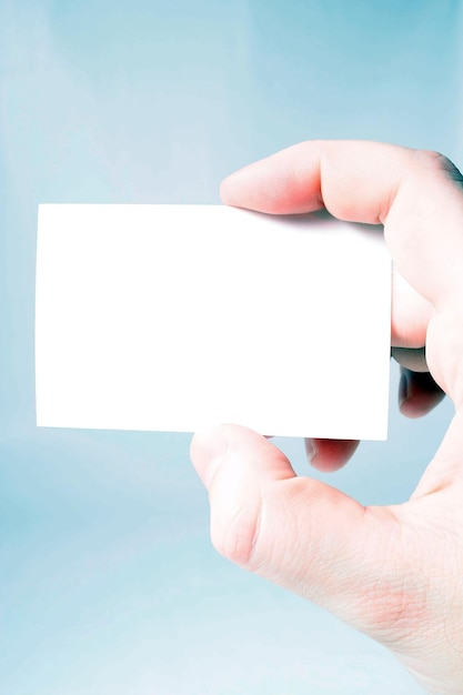 Cropped image of holding blank business card