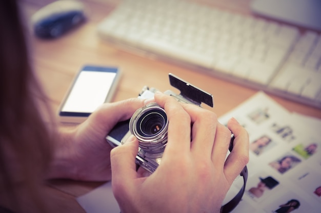 Cropped image of man adjusting camera lens