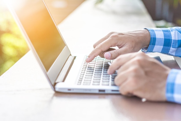 Cropped image of man doing online shopping at desk