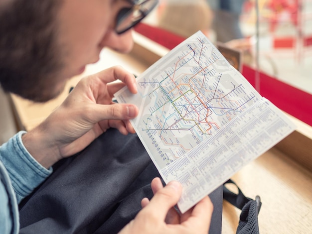 Photo cropped image of man looking at route map